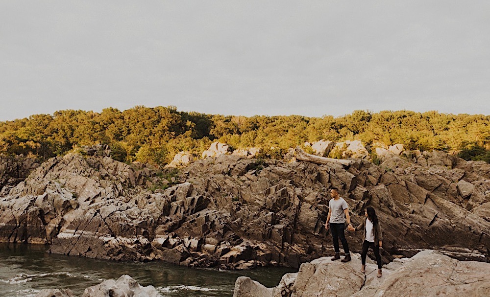 couple stands on cliffs at great falls park